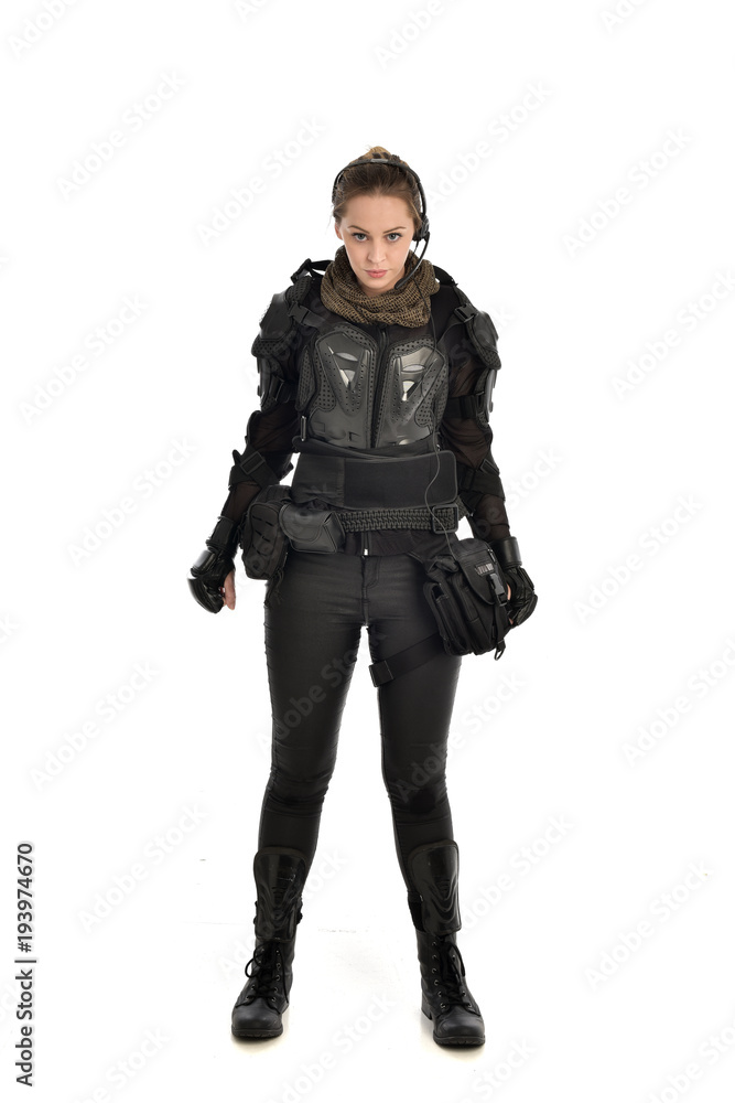 full length portrait of female soldier wearing black tactical armour, isolated on white studio background. full length portrait of female soldier wearing black tactical armour, isolated on white studio background.