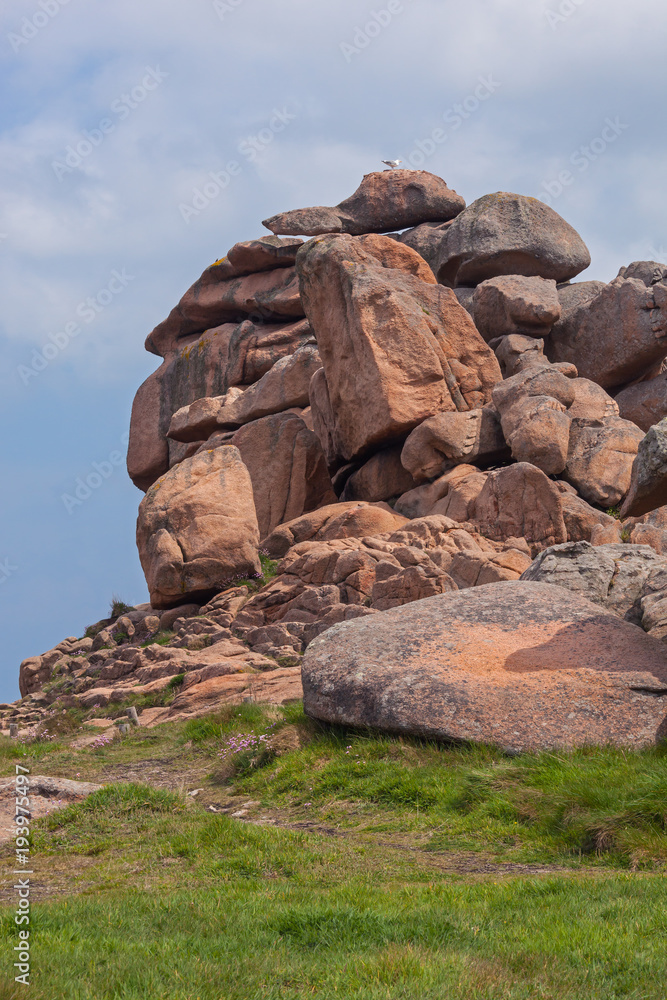 Unusual rock formation on Pink Granite Coast in Ploumanac'h site of Perros-Guirec commune in the north of Brittany in sunny spring day, France Unusual rock formation on Pink Granite Coast in Ploumanac'h site of Perros-Guirec commune in the north of Brittany in sunny spring day, France