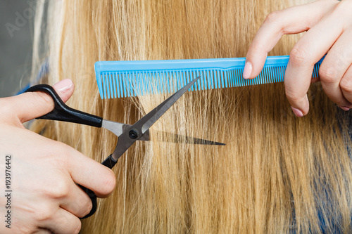 Woman cutting down smoothy hair. photo