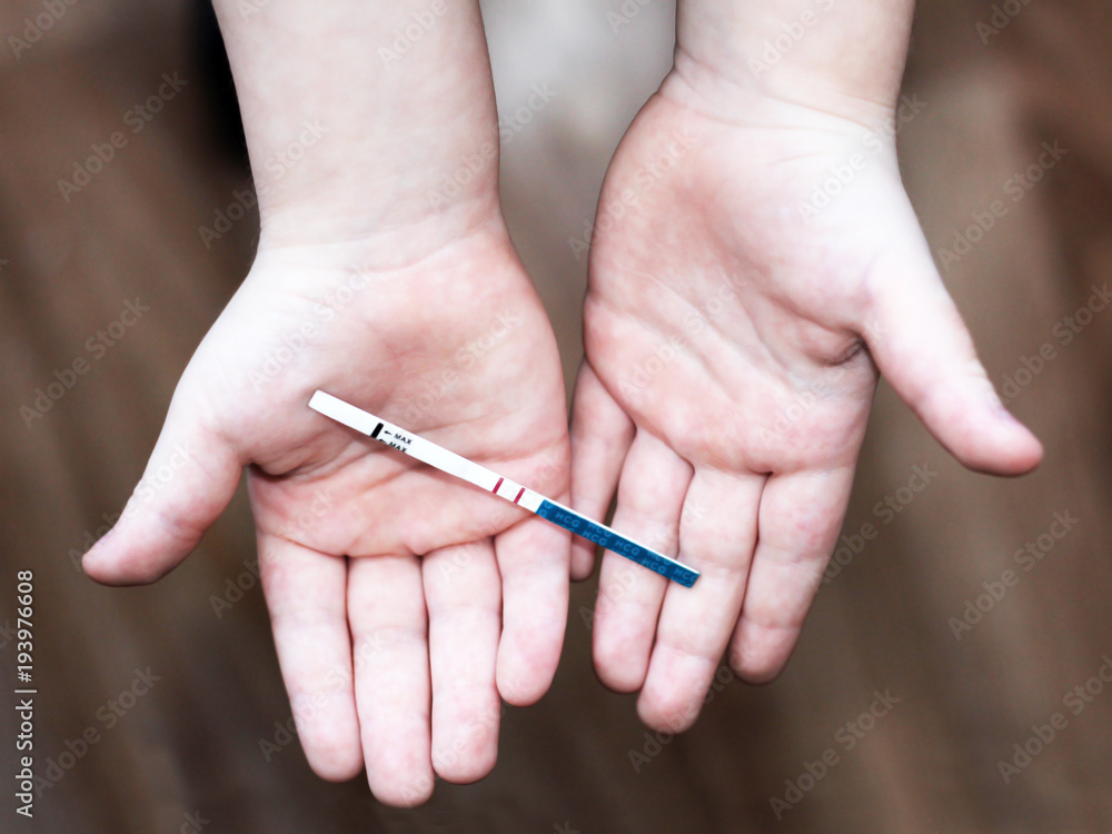 Pregnancy test in in children's hands Pregnancy test in in children's hands