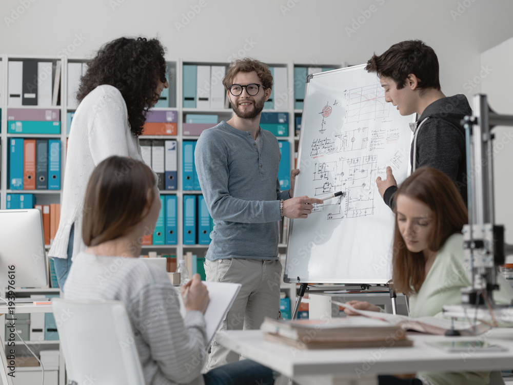 Fototapeta premium Engineering students discussing ideas together