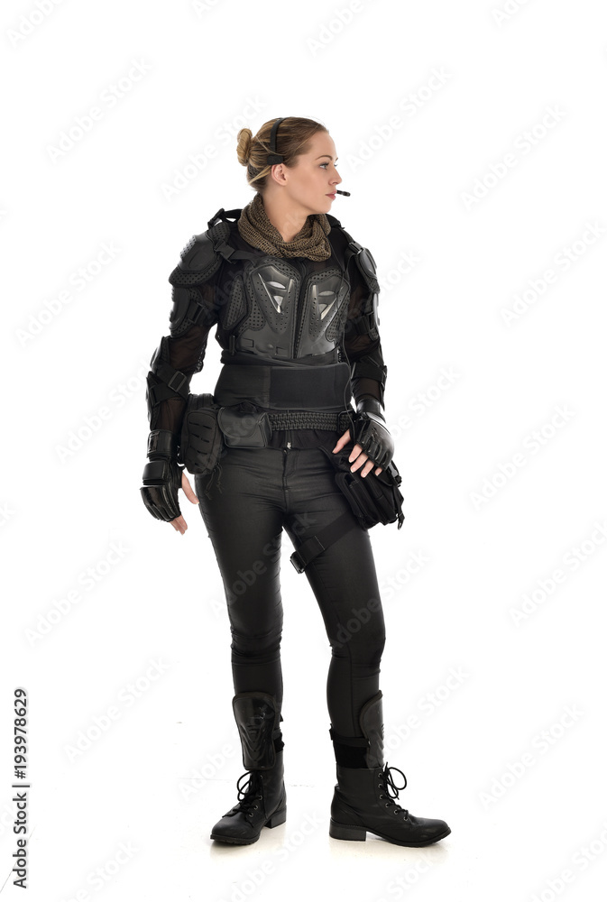 full length portrait of female soldier wearing black tactical armour, isolated on white studio background. full length portrait of female soldier wearing black tactical armour, isolated on white studio background.