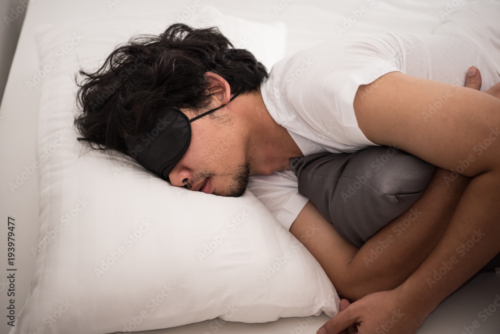 Laziness of Asian man that still sleeping on the bed in bedroom in morning, time to wake up. Laziness of Asian man that still sleeping on the bed in bedroom in morning, time to wake up.