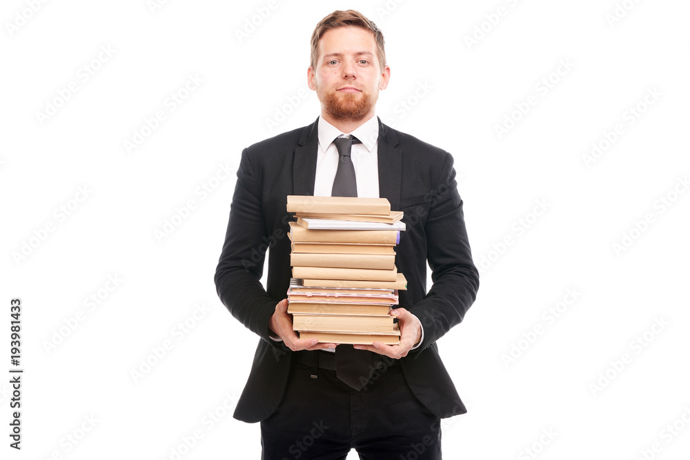 Portrait of young manager holding stack of books Portrait of young manager holding stack of books