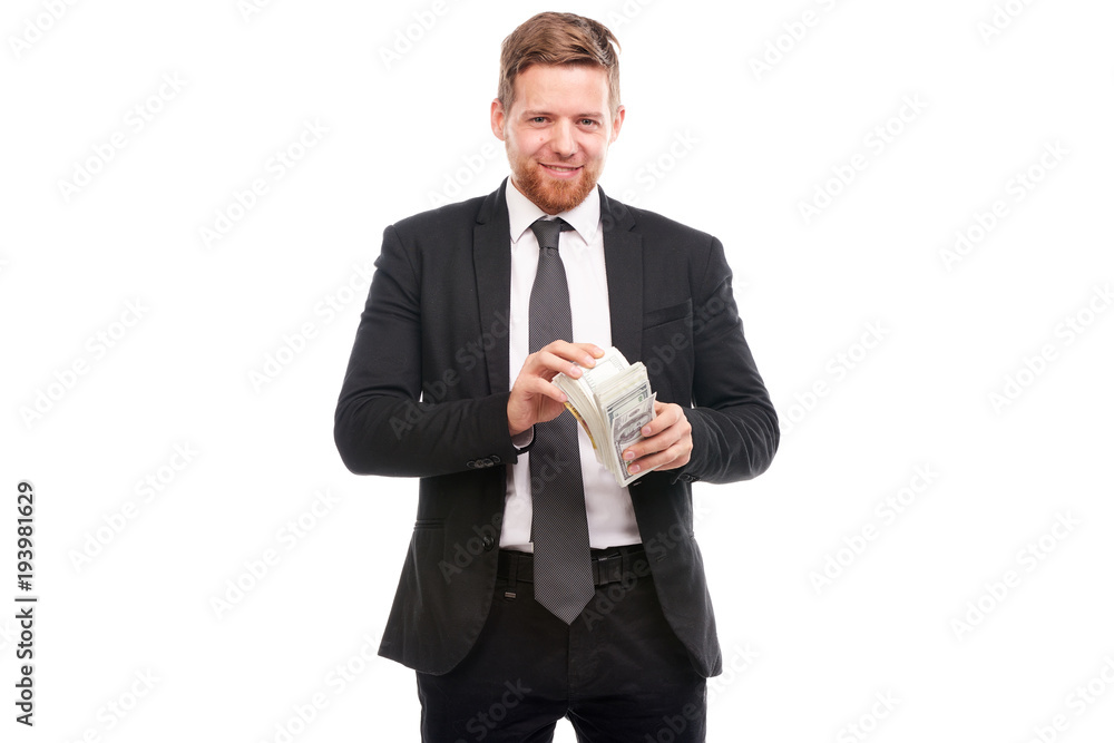 Studio portrait of young businessman holding stack of dollar bill Studio portrait of young businessman holding stack of dollar bill