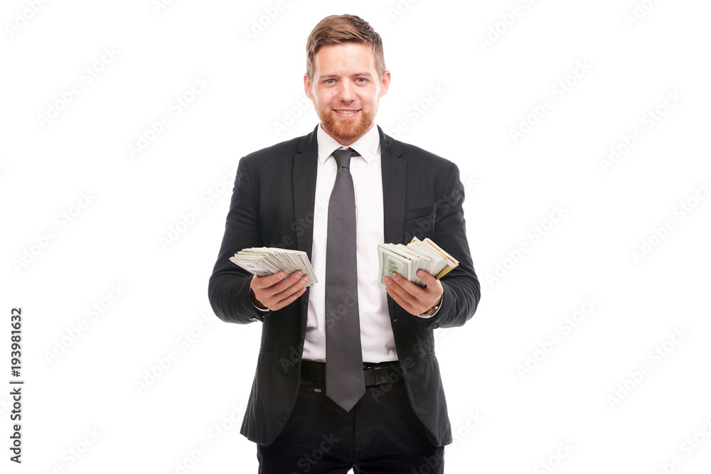 Studio portrait of young businessman holding stack of dollar bill Studio portrait of young businessman holding stack of dollar bill