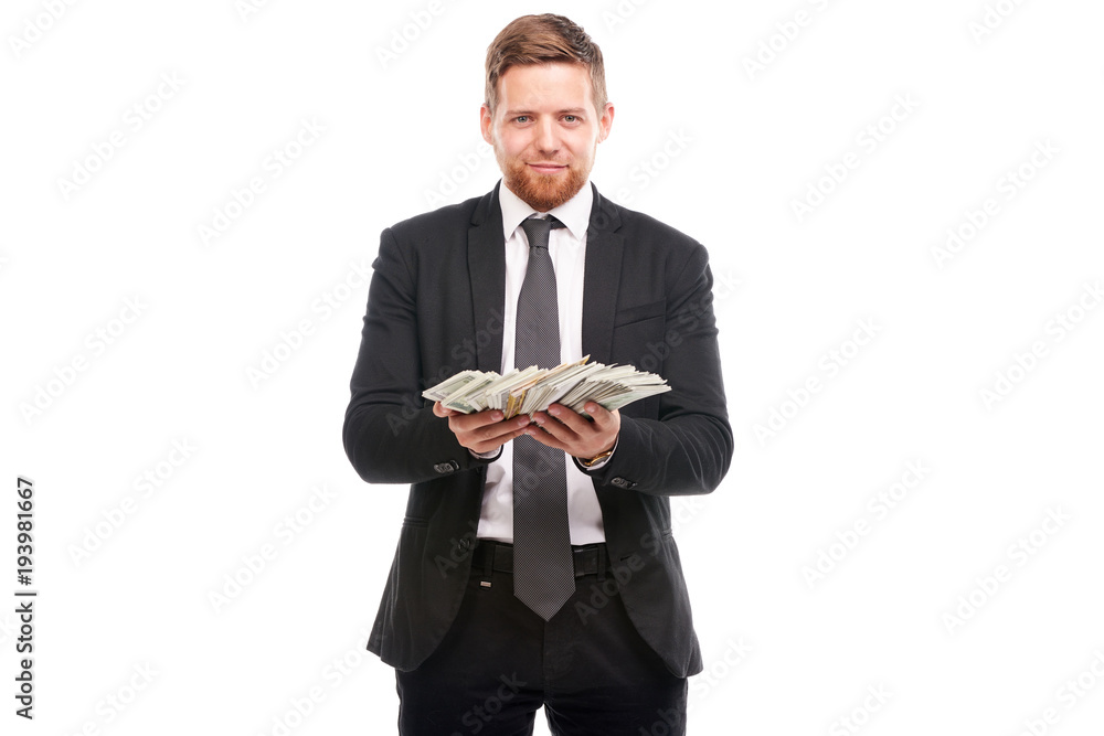 Studio portrait of young businessman holding stack of dollar bill Studio portrait of young businessman holding stack of dollar bill