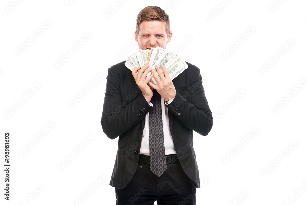 Studio portrait of young businessman holding stack of dollar bill Studio portrait of young businessman holding stack of dollar bill