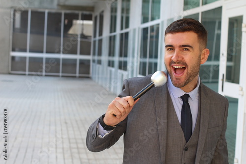 Businessman holding a microphone in office space