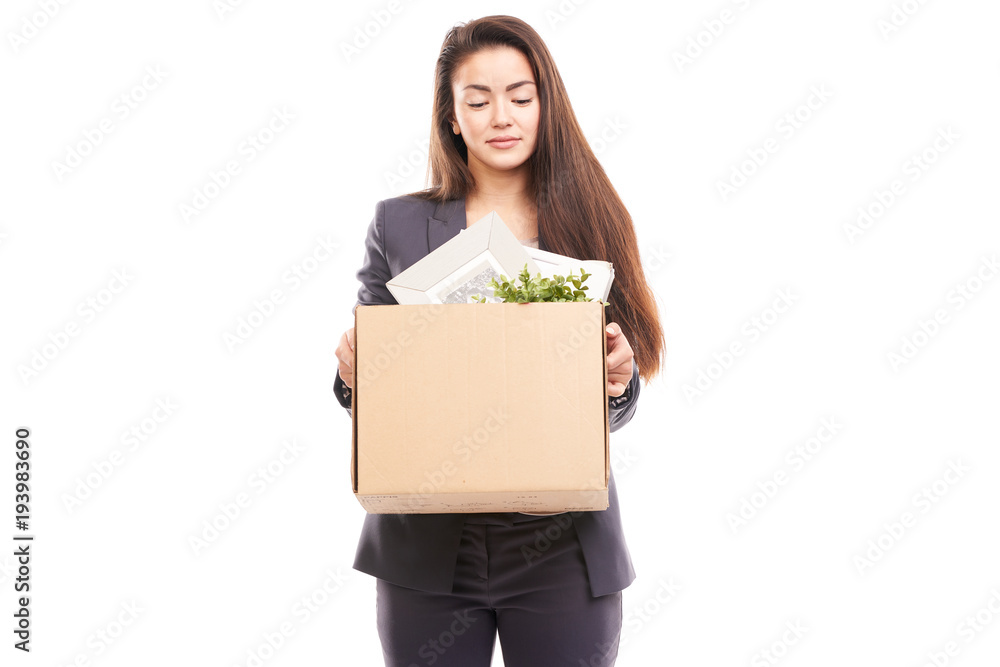Portrait of young businesswoman holding box with personal belongings Portrait of young businesswoman holding box with personal belongings