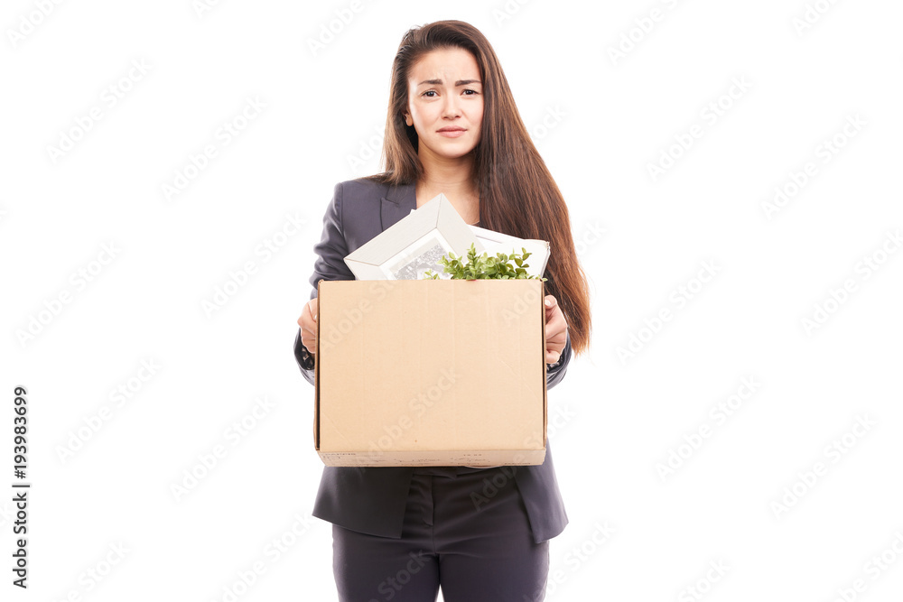 Portrait of young businesswoman holding box with personal belongings Portrait of young businesswoman holding box with personal belongings