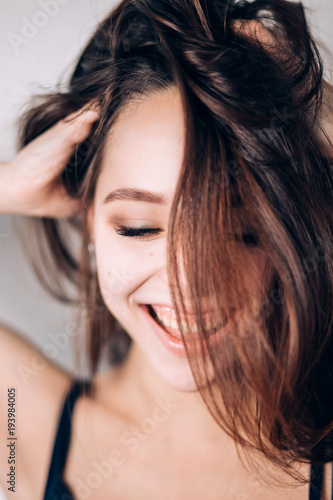 Smiling happy woman. Crazy girl on white background. Look down, wide smile, laughter