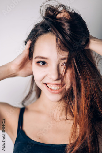 Crazy emotional girl on white background. Portrait of a beautiful young smiling woman
