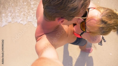 Couple of lovers kissing on the beach on a clear sunny day. 4k, slow motion