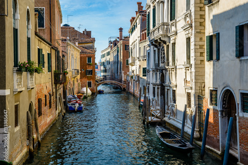 An old canal in Venice with boats parked near entrances of residential buildings © Deyan