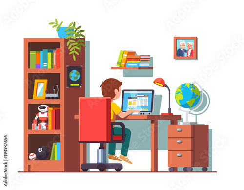 Student boy sitting at desk, doing school homework