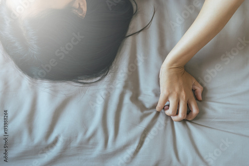 Fotografie Hand woman sign orgasm,Hand female pulling bedsheet,Concept of sexual relations