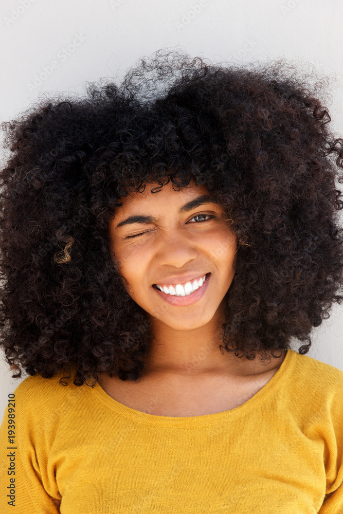 Close up pretty young black woman winking eye and smiling Close up pretty young black woman winking eye and smiling