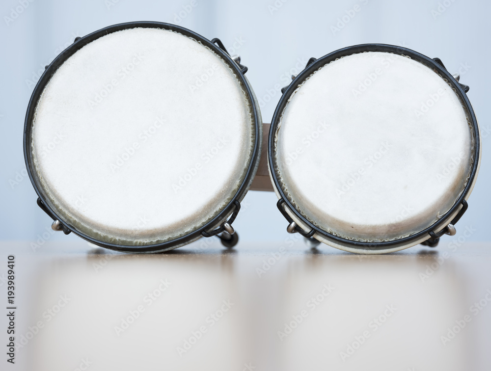 pair of bongos for children on reflecting surface in studio