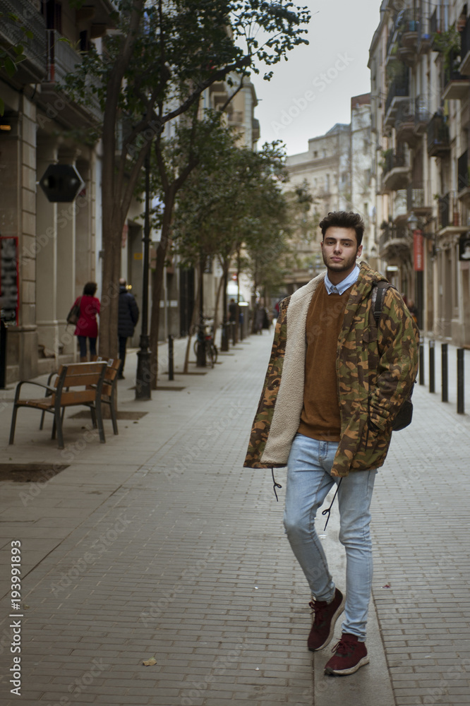 young man walking on the old town city center young man walking on the old town city center