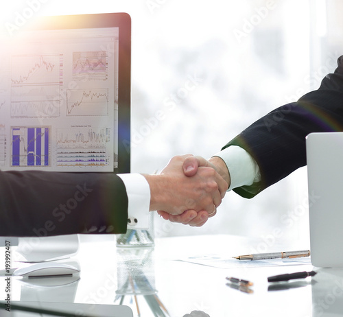 businessman welcomes business partner shaking hands