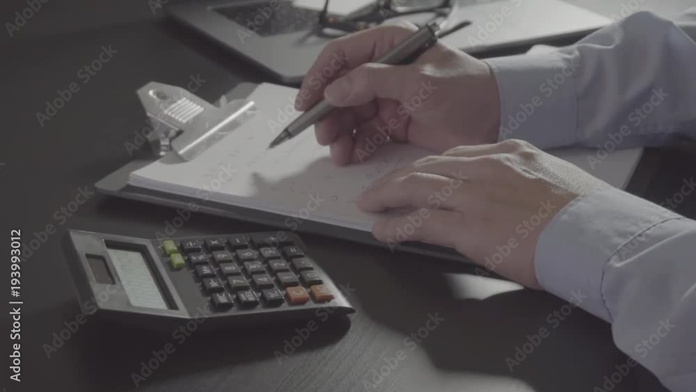businessman hand working with finances about cost and calculator and laptop with mobile phone on withe desk in modern office
businessman hand working with finances about cost and calculator and laptop with mobile phone on withe desk in modern office