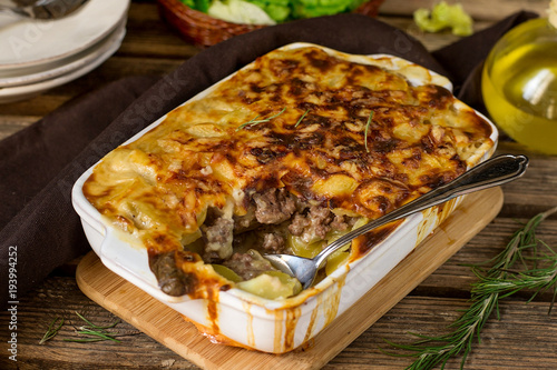 Oven dish potato gratin with minced beef and bechamel sauce