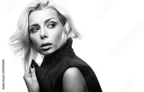 Black and white fashion portrait of beautiful young woman in a black jacket, isolated on a white background
