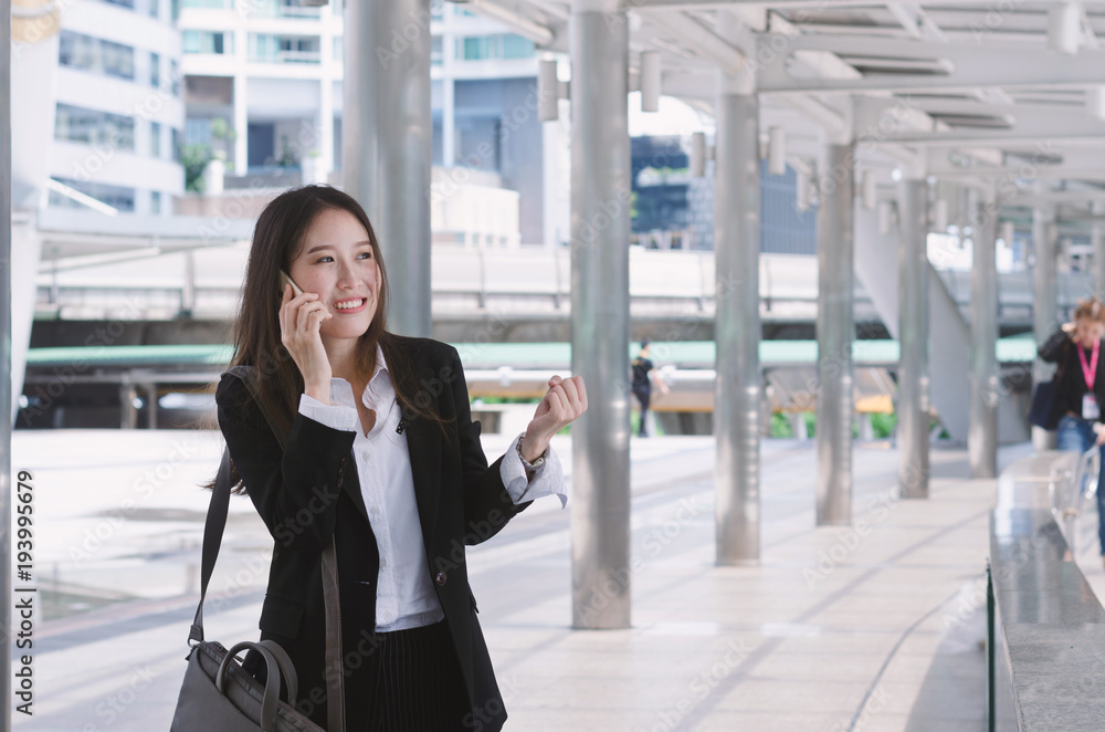 portrait of attractive business woman talking smartphone at outdoor in the modern city. portrait of attractive business woman talking smartphone at outdoor in the modern city.
