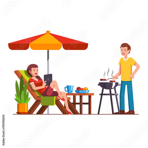 Husband doing barbecue, wife lying on lounger