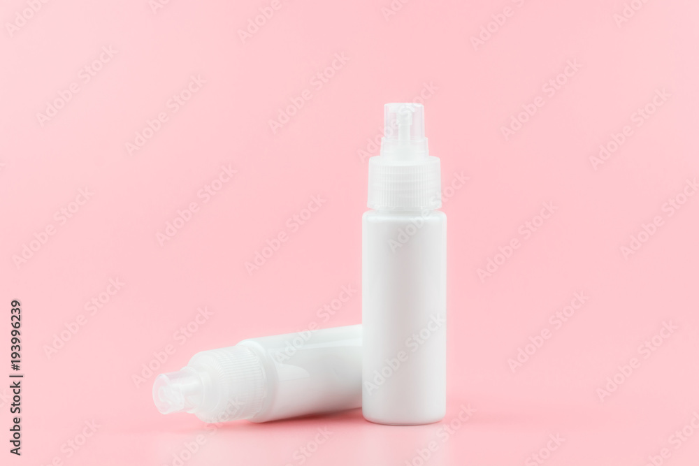 White cosmetic plastic bottle with pump packaging for cream, lotion, medicine, shampoo or liquid soap isolated on pastel pink background. Blank skincare beauty product template. White cosmetic plastic bottle with pump packaging for cream, lotion, medicine, shampoo or liquid soap isolated on pastel pink background. Blank skincare beauty product template.
