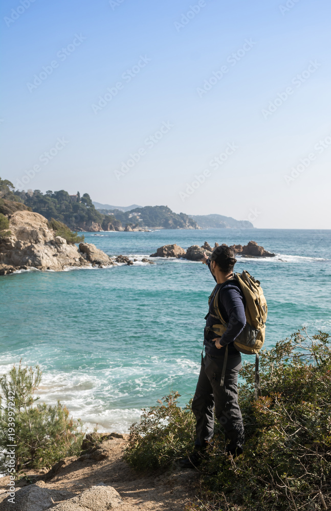 man walking among the rocks near a beach paradise man walking among the rocks near a beach paradise