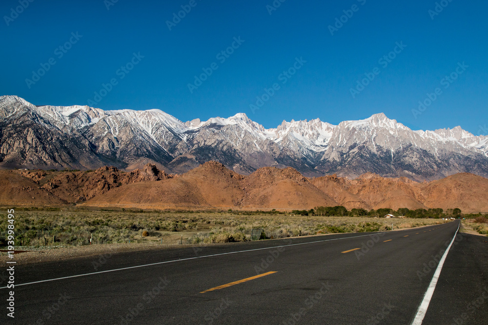 Sierra Nevada Great Eastern Escarpment mountain range covered by snow on the peaks view from the highway 190 Sierra Nevada Great Eastern Escarpment mountain range covered by snow on the peaks view from the highway 190