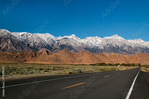 Sierra Nevada Great Eastern Escarpment mountain range covered by snow on the peaks view from the highway 190