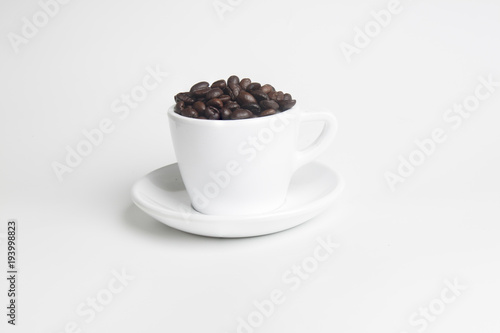 coffee beans in white cup on white background