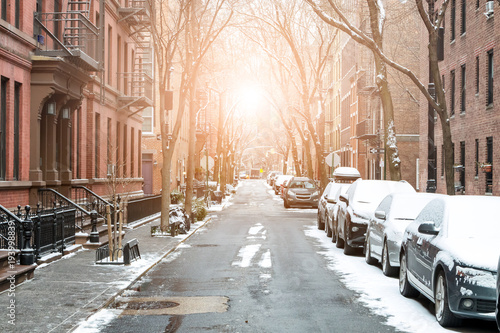 Sunlight shines on snow covered Barrow Street in Greenwich Village, Manhattan New York City © deberarr