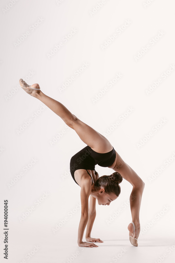Young gymnast girl stretching and training Young gymnast girl stretching and training