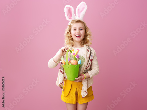 happy stylish child showing festive Easter eggs basket
