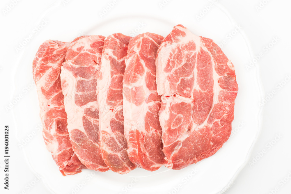Raw pork neck meat cuts on a plate top view isolated on white background fresh five slices without bone. Raw pork neck meat cuts on a plate top view isolated on white background fresh five slices without bone.