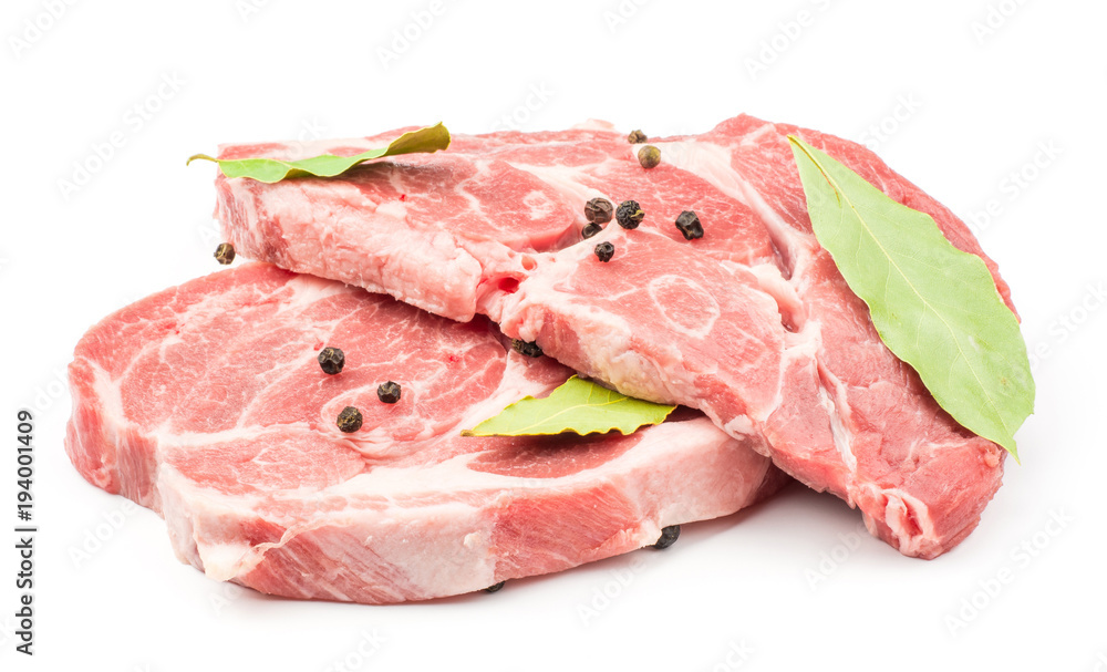 Raw pork neck meat cuts with black pepper and bay leaves isolated on white background fresh two slices without bone .
