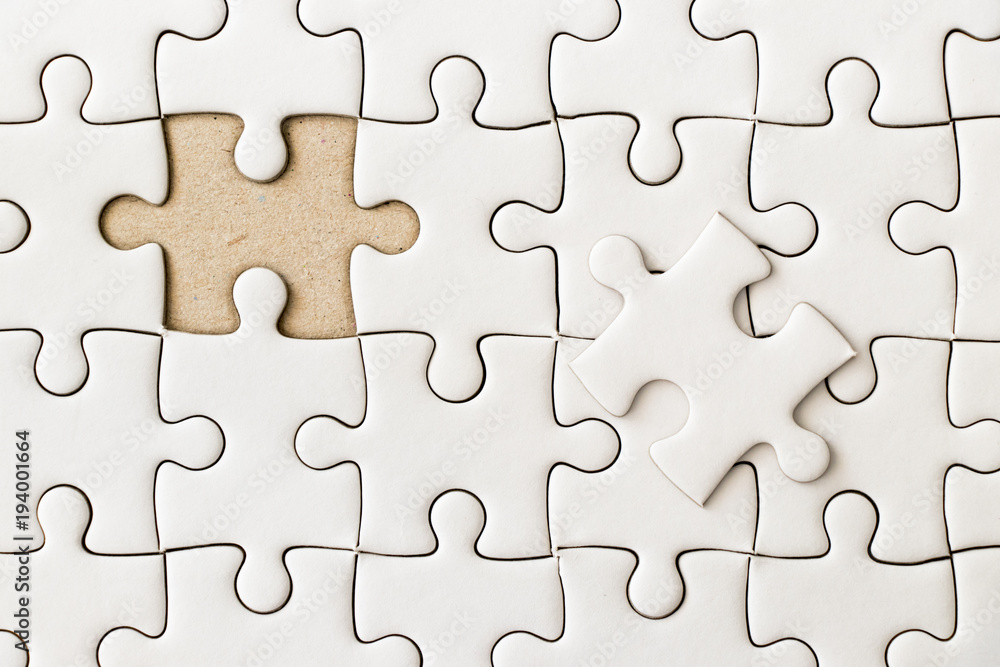 Closed up background of white plain jigsaw wait missing piece to match or fulfill Closed up background of white plain jigsaw wait missing piece to match or fulfill