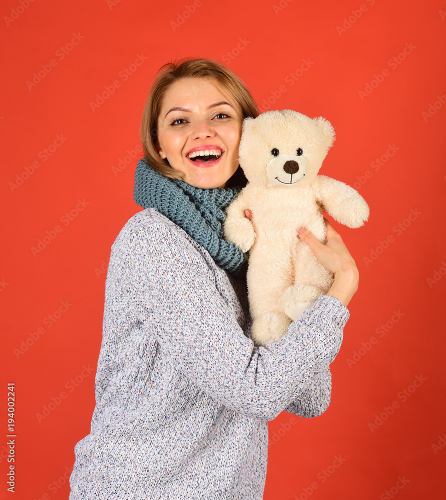 Fototapeta premium Girl with happy face plays with white soft toy.