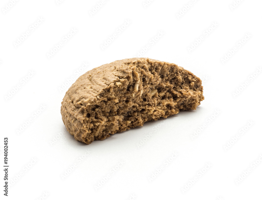 One cracked cocoa oat cookie half isolated on white background drop shape brown crispy biscuit. One cracked cocoa oat cookie half isolated on white background drop shape brown crispy biscuit.