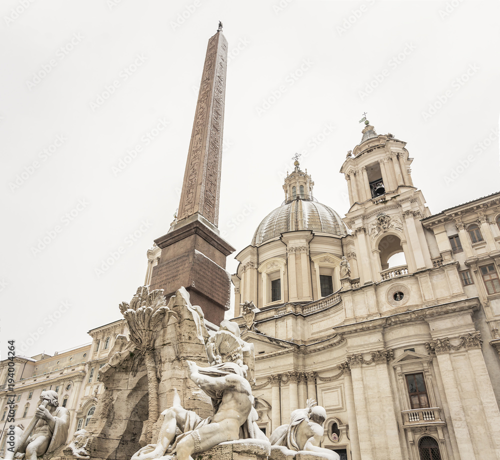 the fountain of the four rivers and the facade of the church of saint agnese in piazza Navona in Rome covered with snow