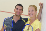 two happy smiling tennis players posing indoor