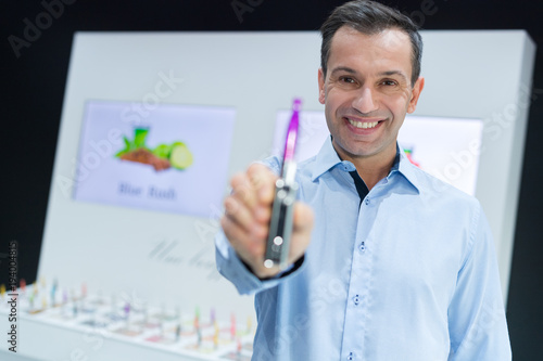 middle-aged man presenting an electronic cigarette