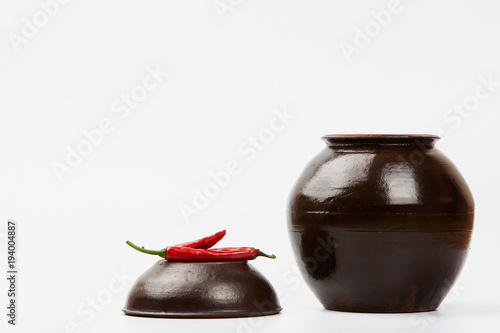 Chili peppers at Crock on white