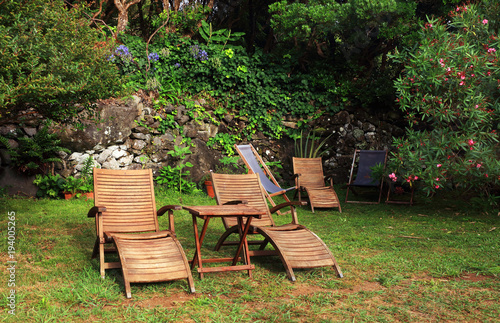 Wooden chairs for relaxing in a green garden