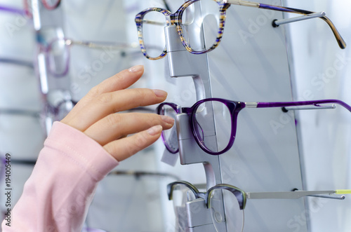 Closeup woman choosing glasses 