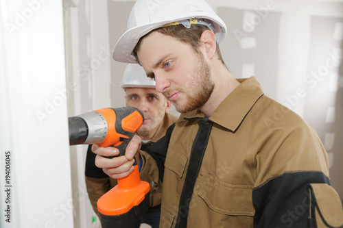 Young tradesman using cordless drill